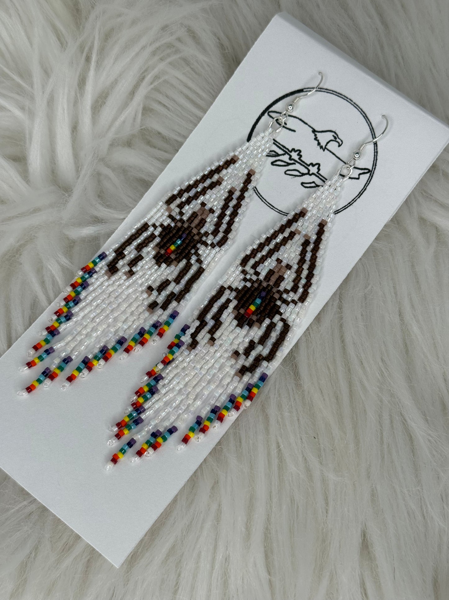 Beaded white fringe earrings with brown spider and rainbow tips